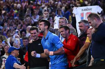 epa10438074 An emotional Novak Djokovic of Serbia celebrates from his players box following his win in the Men s Singles Final against Stefanos Tsitsipas of Greece at the 2023 Australian Open tennis tournament in Melbourne, Australia, 29 January 2023.  EPA/JOEL CARRETT AUSTRALIA AND NEW ZEALAND OUT