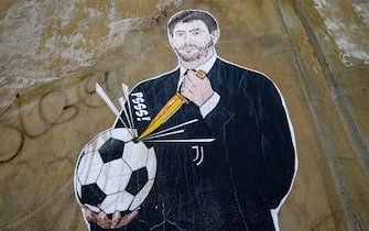 The Football Factory - (in) Faithful to the tribe, the latest work by street artist Laika_mcmliv on the Superlega story features Andrea Agnelli puncturing a soccer ball with a dagger, in Rome, Italy, 21 April 2021. ANSA/FABIO FRUSTACI
