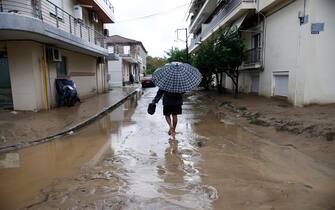 epa10843211 A man walks through a flooded road during the storm named Daniel in the area of Volos, Magnesia, Greece, 06 September 2023. The storm 'Daniel' sweeping through most of Greece with heavy rain and lightning caused extensive damage in the power network at Volos, Mt. Pilio, elsewhere in the Magnissia prefecture, as well as in the Sporades Islands.  EPA/YANNIS KOLESIDIS