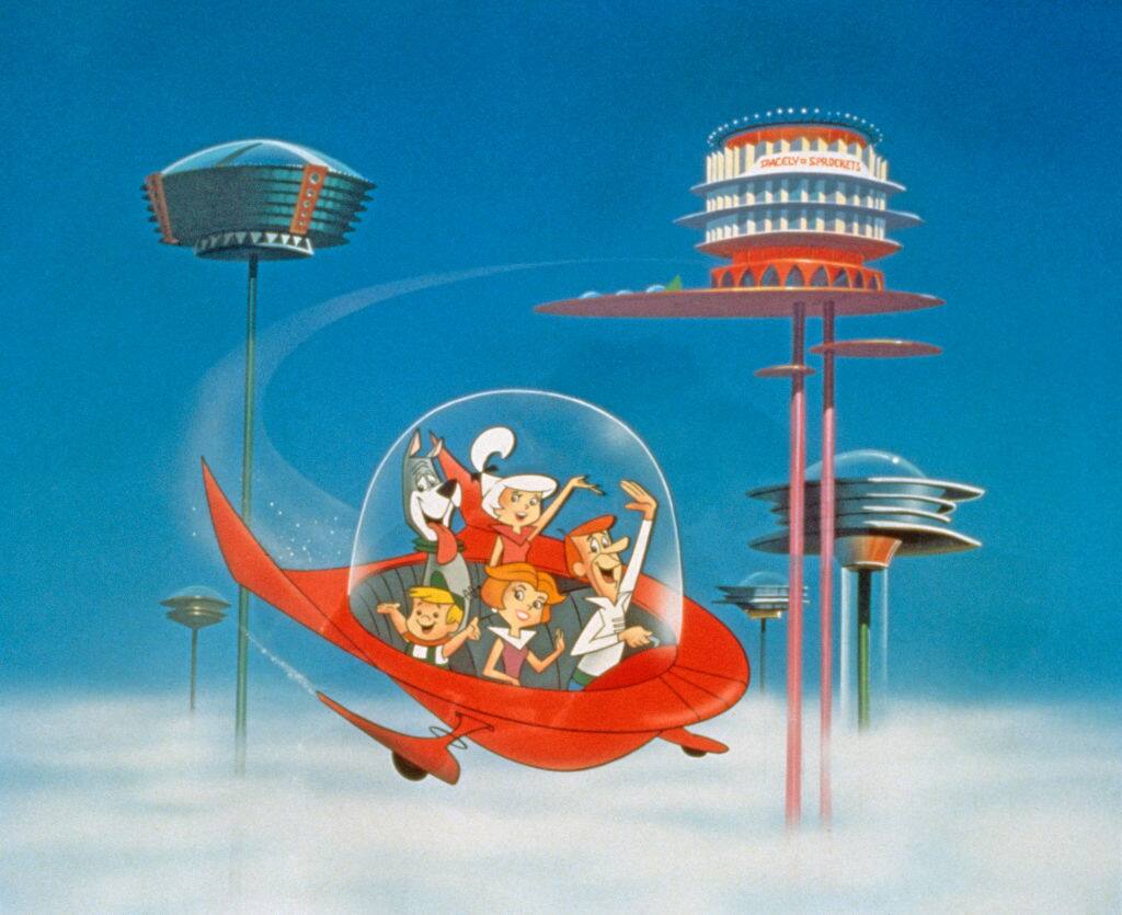 The Jetson family wave as they fly past buildings in space in their spaceship in a still from the animated television series, 'The Jetsons,' circa 1962. (Photo by Warner Bros./Courtesy of Getty Images)