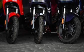 Yogyakarta, Indonesia - September 16, 2023: Brand new electric scooter motorbikes tires or wheels are for sale to customers. Electric motorbike shop. Concept for renewable energy, global warming.