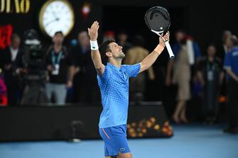 epa10437934 Novak Djokovic of Serbia celebrates winning the men s singles final against Stefanos Tsitsipas of Greece at the 2023 Australian Open tennis tournament in Melbourne, Australia, 29 January 2023.  EPA/James Ross AUSTRALIA AND NEW ZEALAND OUT