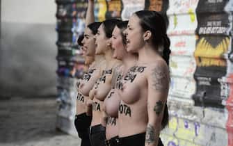 epa11107851 Members of the feminist activist group 'Femen' show the motto 'Who mistreats is not a patriot' and 'who murders us is not a patriot' on their nude torsos as they protest to denounce violence against women, in downtown Madrid, Spain, 27 January 2024.  EPA/VICTOR LERENA