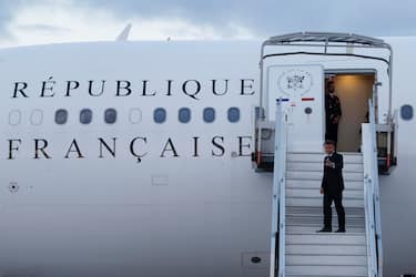 epa11358926 France's President Emmanuel Macron waves as he boards his Presidential aeroplane to travel to the Pacific archipelago of New Caledonia in an attempt to resolve a political crisis, at the Orly airport, suburb of Paris, France, 21 May 2024. The President's trip comes on the heels of military evacuation flights for Australians and New Zealanders from the small Magenta domestic airport in New Caledonia's capital Noumea, which touched down in Brisbane and Auckland in the evening of 21 May.  EPA/LUDOVIC MARIN / POOL  MAXPPP OUT