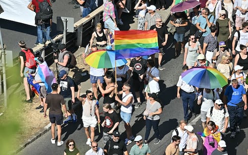 People take part in the Budapest Pride parade in Budapest downtown on June 28, 2025, as the capital's municipality organised this march by the LGBTQ community, celebrating freedom, in a move to circumvent a law that allows police to ban LGBTQ marches. Hungary's Prime Minister had announced that police will not "break up" Saturday's Budapest Pride march despite issuing a ban, but warned attendees and organisers about the legal consequences. His ruling coalition amended laws and the constitution earlier this year to prohibit the annual celebration, advancing his widely condemned, years-long clampdown on LGBTQ rights in the name of "child protection". (Photo by Attila KISBENEDEK / AFP)