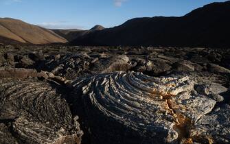 GRINDAVIK, ICELAND - 2023/11/08: A lava field formed after the 2021 eruption of the Fagradalsfjall volcano. The site is located a few kilometers from Grindavik. Iceland is preparing for another volcanic eruption on the Reykjanes peninsula. After more than 1400 earthquakes during the last 48 hours in the Grindavik area, experts warn of a very likely volcanic eruption in the coming days. In 2021, 2022, and 2023, successive volcanic eruptions occurred near the Grindavik area, populated with some 3200 people. For the time being, the well-known Blue Lagoon thermal spa has closed its doors due to the great risk that a volcanic fissure could open up in the same area. (Photo by Raul Moreno/SOPA Images/LightRocket via Getty Images)