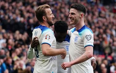 England&#x92;s Bukayo Saka (centre) celebrates scoring his sides second goal with team mates Harry Kane (left) and Declan Rice during the UEFA Euro 2024 Group C qualifying match at Wembley Stadium, London. Picture date: Sunday March 26, 2023.