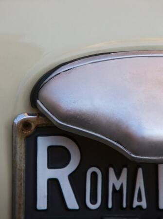 detail of a Roma number plate on a small Italian car