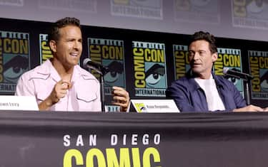 SAN DIEGO, CALIFORNIA - JULY 25: (L-R) Ryan Reynolds and Hugh Jackman speak onstage during Marvel Studios: The Ultimate Deadpool & Wolverine Celebration of Life in Hall H at SDCC in San Diego, California on July 25, 2024. (Photo by Jesse Grant/Getty Images for Disney)