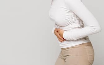 Health issues problems concept.Woman suffering from stomach pain, feeling abdominal pain or cramps.Period menstruation, female health problem, aching
