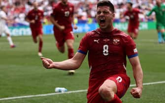 epa11425503 Luka Jovic of Serbia celebrates the 1-1 goal during the UEFA EURO 2024 Group C soccer match between Slovenia and Serbia, in Munich, Germany, 20June 2024.  EPA/ANNA SZILAGYI