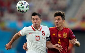 Poland's forward Robert Lewandowski (L) challenges Spain's defender Pau Torres during the UEFA EURO 2020 Group E football match between Spain and Poland at La Cartuja Stadium in Seville, Spain, on June 19, 2021. (Photo by THANASSIS STAVRAKIS / POOL / AFP) (Photo by THANASSIS STAVRAKIS/POOL/AFP via Getty Images)