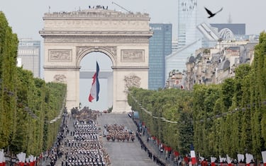 French troops and French President Emmanuel Macron march during the Bastille Day military parade on the Champs-Elysees avenue, with the Arc de Triomphe seen in the background, in Paris on July 14, 2023. (Photo by Ludovic MARIN / AFP) (Photo by LUDOVIC MARIN/AFP via Getty Images)