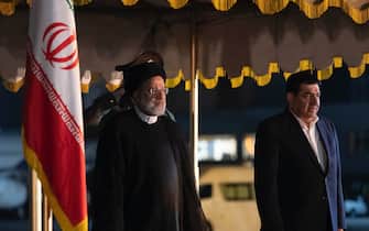 Iranian President Ebrahim Raisi (L), and First Vice President Mohammad Mokhber Dezfuli, stand in attention during a farewell ceremony before leaving Tehran's Mehrabad airport to Indonesia, May 22, 2023. Ebrahim Raisi traveled to Indonesia due to the official invitation of his Indonesian counterpart Joko-Widodo after seventeen years. (Photo by Morteza Nikoubazl/NurPhoto via Getty Images)