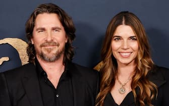 British actor Christian Bale (L) and his wife Sibi Blazic arrive for the premiere of "The Pale Blue Eye" at the DGA theater in Los Angeles, California on December 14, 2022. (Photo by Michael Tran / AFP) (Photo by MICHAEL TRAN/AFP via Getty Images)
