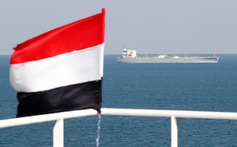 epa11014294 A ship sails offshore of the Al-Salif port as a Yemeni flag flutters on the deck of the Galaxy Leader cargo ship, seized by the Houthis, on the Red Sea in the province of Hodeidah, Yemen, 05 December 2023 (issued 06 December 2023). Yemen's Houthis on 06 December 2023 claimed responsibility for the launch of the barrage of ballistic missiles toward Israel in support of the Palestinian people in the Gaza Strip, according to a statement by Houthis spokesman Yahya Saree. The Houthis vowed to continue their efforts to prevent Israeli ships from navigating in the Arabian and Red Seas, in retaliation for Israel's airstrikes on the Gaza Strip. Thousands of Israelis and Palestinians have died since the militant group Hamas launched an unprecedented attack on Israel from the Gaza Strip on 07 October, and the Israeli strikes on the Palestinian enclave which followed it.  EPA/YAHYA ARHAB