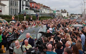 Fans of singer Sinead O'Connor line the streets for a "last goodbye" to the Irish singer as her funeral cortege passes through her former hometown of Bray, Co Wicklow, ahead of a private burial service. Picture date: Tuesday August 8, 2023.