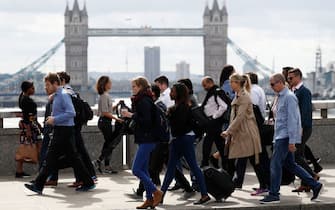 Commuters walk across London Bridge in London on June 5, 2017, after it was partially re-opened following the June 3 terror attack. British police on Monday made several arrests in two dawn raids following the June 3 London attacks, claimed by the Islamic State group which left seven people dead. (Photo by Odd ANDERSEN / AFP) (Photo by ODD ANDERSEN/AFP via Getty Images)
