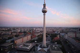 BERLIN, GERMANY - JUNE 18:  The broadcast tower at Alexanderplatz looms over the city center at sunset on June 18, 2014 in Berlin, Germany. Alexanderplatz, a crossing point of tourists, commuters, shoppers, lovers, artists, bums and petty criminals, was built from the rubble of World War II by the communist authorities of former East Germany and today is the nexus of the reunified city.  (Photo by Sean Gallup/Getty Images)