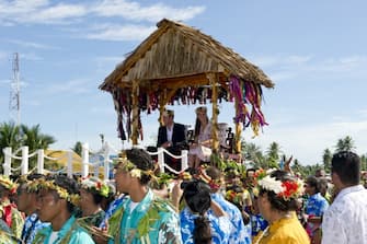 TUVALU - SEPTEMBER 19: Prince William, Duke of Cambridge and Catherine, Duchess of Cambridge are carried as they bid farewell on September 19, 2012 in Tuvalu. Prince William, Duke of Cambridge and Catherine, Duchess of Cambridge are on a Diamond Jubilee tour representing the Queen taking in Singapore, Malaysia, the Solomon Islands and Tuvalu.  (Photo by Arthur Edwards - Pool/Getty Images)