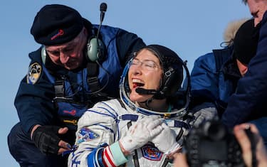 epa08197181 NASA astronaut Christina Koch (front) reacts shortly after landing of the Russian Soyuz MS-13 space capsule in a remote area southeast of Zhezkazgan in the Karaganda region of Kazakhstan, 06 February 2020. A Soyuz space capsule with U.S. astronaut Christina Koch, Russian cosmonaut Alexander Skvortsov and ESA (European Space Agency) astronaut Luca Parmitano, returning from a mission to the International Space Station, landed safely in the steppes of Kazakhstan. Christina Koch returned to the Earth after setting a new record for the longest space mission by a woman.  EPA/SERGEI ILNITSKY / POOL
