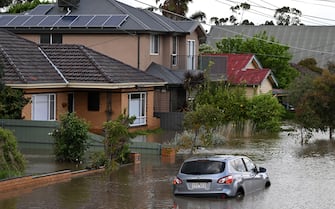 epa10242590 A submerged car is seen in flood waters in Maribyrnong, Melbourne, Australia, 14 October 2022. Victorian residents have been told to move to higher ground as rain continue to pummel vast swathes of the state, causing flooding and thousands of power outages.  EPA/JAMES ROSS  AUSTRALIA AND NEW ZEALAND OUT