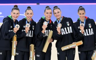 Italy's gymnasts, Martina Centofanti, Agnese Duranti, Alessia Maurelli, Daniela Mogurean and Laura Paris, celebrate on the podium after winning the bronze medal in the Group All-Around Final of the Rhythmic Gymnastics competitions in the Paris 2024 Olympic Games, at the La Chapelle Arena in Paris, France, 10 August 2024. ANSA/ETTORE FERRARI