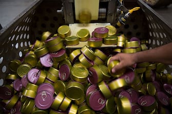 A worker inspects tuna cans as they move down a conveyor belt at the Grupo Pinsa SA processing plant in Mazatlan, Mexico, on Thursday, Sept. 29, 2015. In April the World Trade Organization (WTO) ruled that dolphin-safe labels for canned tuna discriminated against Mexico. The U.S. has appealed the ruling and a final decision is expected later this year. Photographer: Susana Gonzalez/Bloomberg via Getty Images