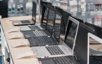 modern male customer choosing laptop in the computer store