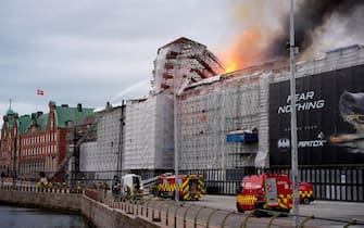 Firefighters spray water to extinguish a fire that broke out in the Copenhagen's Stock Exchange building, in Copenhagen, on April 16, 2024. (Photo by Emil Helms / Ritzau Scanpix / AFP) / Denmark OUT