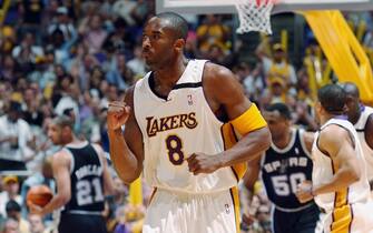 LOS ANGELES - MAY 11:  Kobe Bryant #8 of the Los Angeles Lakers pumps his fist as he runs down the court against the San Antonio Spurs in Game four of the Western Conference Semifinals during the 2003 NBA Playoffs at Staples Center on May 11, 2003 in Los Angeles, California.  The Lakers won 99-95.  NOTE TO USER: User expressly acknowledges and agrees that, by downloading and/or using this Photograph, User is consenting to the terms and conditions of the Getty Images License Agreement Mandatory Copyright Notice:  Copyright 2003 NBAE  (Photo by Noah Graham/NBAE via Getty Images) 