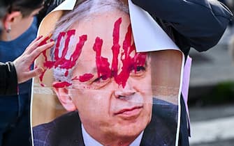 Protestors stain a picture of Italian minister of the interior Matteo Piantedosi during a rally held next to town harbour to contest ministers Matteo Piantedosi and Matteo Salvini after Pisa clashes in Genoa, Italy, 4 March 2024. ANSA/SIMONE ARVEDA