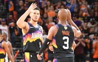 PHOENIX, AZ - JULY 6: Devin Booker #1 of the Phoenix Suns high fives Chris Paul #3 of the Phoenix Suns during the game against the Milwaukee Bucks during Game One of the 2021 NBA Finals on July 6, 2021 at Phoenix Suns Arena in Phoenix, Arizona. NOTE TO USER: User expressly acknowledges and agrees that, by downloading and or using this photograph, user is consenting to the terms and conditions of the Getty Images License Agreement. Mandatory Copyright Notice: Copyright 2021 NBAE (Photo by Andrew D. Bernstein/NBAE via Getty Images)