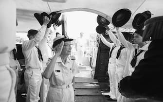 (Original Caption) Boston: Rear Admiral Grace M. Hopper salutes crew members as she comes aboard the US S Constitution in Boston's Charlestown section for her retirement ceremony 8/14. Hopper, the U. S. Navy's oldest commissioned officer on active duty, retired after serving over 40 years in a Navy uniform. The 188-year-old U. S. S. Constitution is the oldest still commissioned warship afloat in the world.