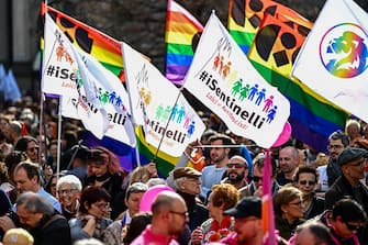 People take part in a demonstration by gay rights and civil society groups in Milan on March 18, 2023, against moves by Italy's right-wing government to restrict the rights of same-sex parents. (Photo by GABRIEL BOUYS / AFP) (Photo by GABRIEL BOUYS/AFP via Getty Images)