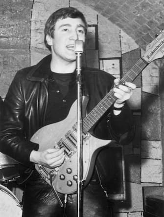 December 1961:  Singer, guitarist and songwriter John Lennon (1940 - 1980) of the British group The Beatles live on stage at the Cavern Club in Matthew Street, Liverpool.  (Photo by Evening Standard/Getty Images)