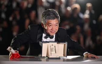 Japanese director Kore-Eda Hirokazu poses with the trophy during a photocall after he accepted the Best Screenplay prize for the film "Kaibutsu" (Monster) on behalf of Japanese writer Sakamoto Yuji during the closing ceremony of the 76th edition of the Cannes Film Festival in Cannes, southern France, on May 27, 2023. (Photo by Patricia DE MELO MOREIRA / AFP) (Photo by PATRICIA DE MELO MOREIRA/AFP via Getty Images)