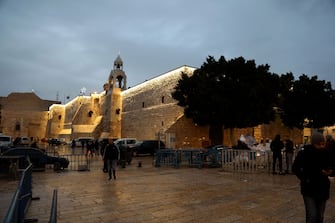 BETHLEHEM, WEST BANK - DECEMBER 23: A general view of the Church of the Nativity, built on a cave where Jesus Christ is believed to have been born, with only one side illuminated as all Christmas celebrations are limited due to the Israeli-Palestinian conflict in Bethlehem, West Bank on December 23, 2023. Due to Israel's attacks on Gaza, the streets of the city were not decorated for Christmas this year as in previous years. In the city, where festive activities were avoided, the streets were not decorated with lights as in previous years and the Christmas tree in front of the Church of the Nativity (Mehd) was not illuminated. While the courtyard of the Church of the Nativity is filled with visitors every year, this year it was almost empty. (Photo by Wesam Hashlamon/Anadolu via Getty Images)
