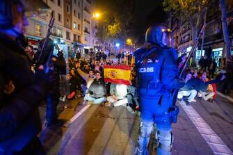 MADRID, SPAIN - 2023/11/09: Riot police confront protesters during a protest in front of socialist party PSOE headquarters in Ferraz street for the seventh consecutive day of protests following the recent agreement between PSOE and Junts party, which unfolded today in Brussels. Thousands responded to a call by far right groups to protest the approval of an amnesty for Catalan separatist leaders which is included in the agreement and guarantees the investiture of the socialist candidate Pedro Sanchez. (Photo by Marcos del Mazo/LightRocket via Getty Images)