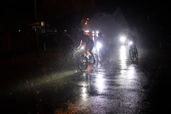 epa10457883 Riders race through the wet streets of downtown Johannesburg during the monthly Jozi Hustle underground bicycle race held through the streets of Johannesburg, South Africa, 09 February 2023. The monthly bicycle race sees riders of all ages and riding backgrounds tackle a 22 km course through the dark night time streets of the city chasing the converted 'floating trophy'. The race has been held for the past ten years and starts and finishes at a popular cycling venue Cafe Casquette. The main group of riders race at speeds of up to 45km/h as they follow the same route each month.  EPA/KIM LUDBROOK ATTENTION: This Image is part of a PHOTO SET