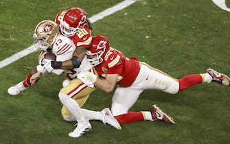 epa11146414 San Fransisco 49ers quarterback Brock Purdy (L) is tackled by the Chiefs' George Karlaftis (R) and Justin Reid (2-R) during the first half of Super Bowl LVIII between the Kansas City Chiefs and the San Fransisco 49ers at Allegiant Stadium in Las Vegas, Nevada, USA, 11 February 2024. The Super Bowl is the annual championship game of the NFL between the AFC Champion and the NFC Champion and has been held every year since 1967.  EPA/CAROLINE BREHMAN
