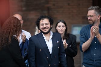 Patrick Zaki, the Egyptian activist, graduated from the University of Bologna, in Piazza Maggiore, at the party for his return, Bologna, 30 July 2023. "I thank the whole city, which allowed my liberation. This is a city of freedom and human rights. I am happy to be here in person, finally, after years of online calls," he said.    ANSA / MAX CAVALLARI