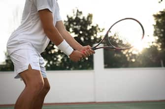 Caucasian man training on a tennis court