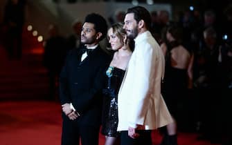 (From L) Canadian singer Abel Makkonen Tesfaye aka The Weeknd, French-US actress Lily-Rose Depp and US director Sam Levinson arrive for the screening of the film "The Idol" during the 76th edition of the Cannes Film Festival in Cannes, southern France, on May 22, 2023. (Photo by CHRISTOPHE SIMON / AFP) (Photo by CHRISTOPHE SIMON/AFP via Getty Images)