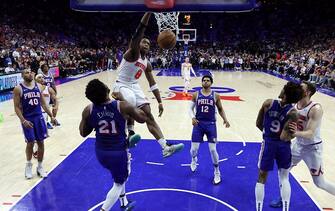 PHILADELPHIA, PENNSYLVANIA - MAY 02: OG Anunoby #8 of the New York Knicks dunks past Joel Embiid #21 of the Philadelphia 76ers during the second half of game six of the Eastern Conference First Round Playoffs at the Wells Fargo Center on May 02, 2024 in Philadelphia, Pennsylvania. NOTE TO USER: User expressly acknowledges and agrees that, by downloading and/or using this Photograph, user is consenting to the terms and conditions of the Getty Images License Agreement. (Photo by Tim Nwachukwu/Getty Images)