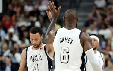 LAS VEGAS, NEVADA - JULY 10: Stephen Curry #4 and LeBron James #6 of the United States high-five in the second half of their exhibition game against Canada ahead of the Paris Olympic Games at T-Mobile Arena on July 10, 2024 in Las Vegas, Nevada. The United States defeated Canada 86-72. (Photo by Ethan Miller/Getty Images)