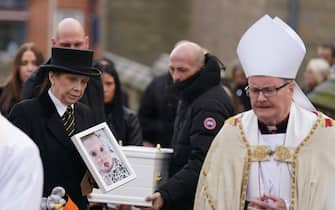 The father of Indi Gregory, Dean Gregory (partially hidden left) carries the casket of his daughter from St Barnabus Cathedral, Nottingham, following her funeral service. The baby girl died shortly after her life-support treatment was withdrawn after her parents, Mr Gregory and Claire Staniforth who are both in their 30s and from Ilkeston, Derbyshire, lost legal bids in the High Court and Court of Appeal in London for specialists to keep treating her. Picture date: Friday December 1, 2023.