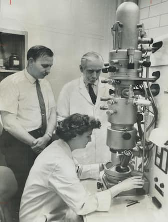 Atkinson Charitable Foundation gift of $36;300 to the Ontario Cancer Institute in Toronto was denoted to duplicate this powerful electron microscope. It is urgently needed to aid research. It is urgently needed to aid research. At miscroscope is Mrs. June Almeida. Behind her Dr. Donald Parsons; in back is Dr. Arthur W. H.