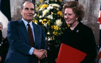 CANTERBURY, ENGLAND - FEBRUARY 12: (FILE PHOTO) French President Francois Mitterrand and British Prime Minister Margaret Thatcher shake hands at the signing of the Channel Tunnel (Chunnel) agreement in Canterbury Cathedral on  February 12, 1986. (Photo by David Levenson/Getty Images)