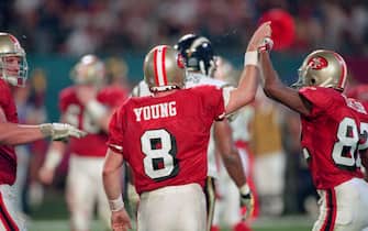 MIAMI, FL- JANUARY 29:  Steve Young #8 and John Taylor #82 of the San Francisco 49ers celebrates after they scored a touchdown against the San Diego Chargers during Super Bowl XXIX on January 29, 1995 at Joe Robbie Stadium in Miami, Florida. The Niners won the Super Bowl 49-26. (Photo by Focus on Sport/Getty Images)